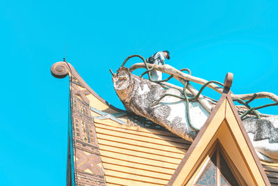 Low angle view of crane against clear blue sky