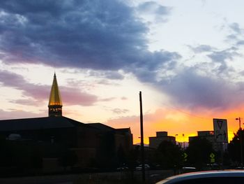 Silhouette buildings against sky during sunset