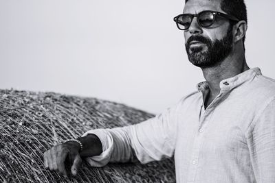 Man wearing eyeglasses against clear sky