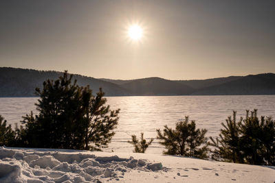 Scenic view of lake against sky during winter