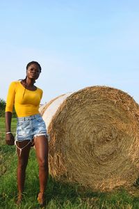Full length of man standing on field against clear sky