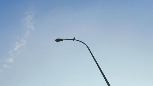 Low angle view of street light against blue sky