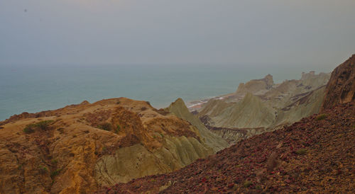 Scenic view of sea and mountains against sky