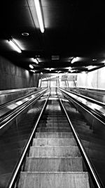 High angle view of empty escalators in illuminated subway station