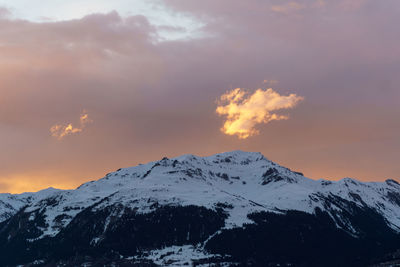 Scenic view of snowcapped mountains against sky during sunset