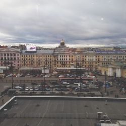 Buildings against cloudy sky