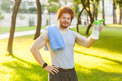 Portrait of smiling man standing against plants