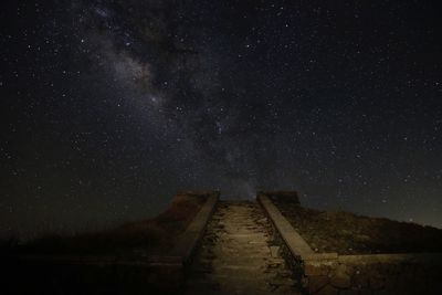 Low angle view of old ruin against sky at night