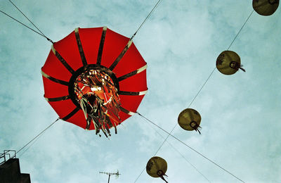 Low angle view of lanterns hanging against sky