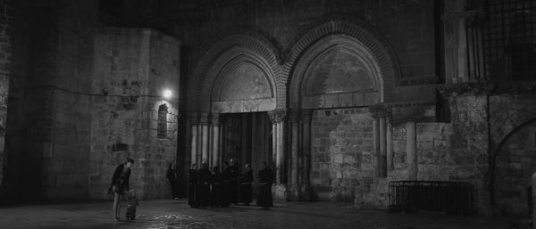 People walking in front of historic church