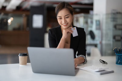 Young woman using laptop at table