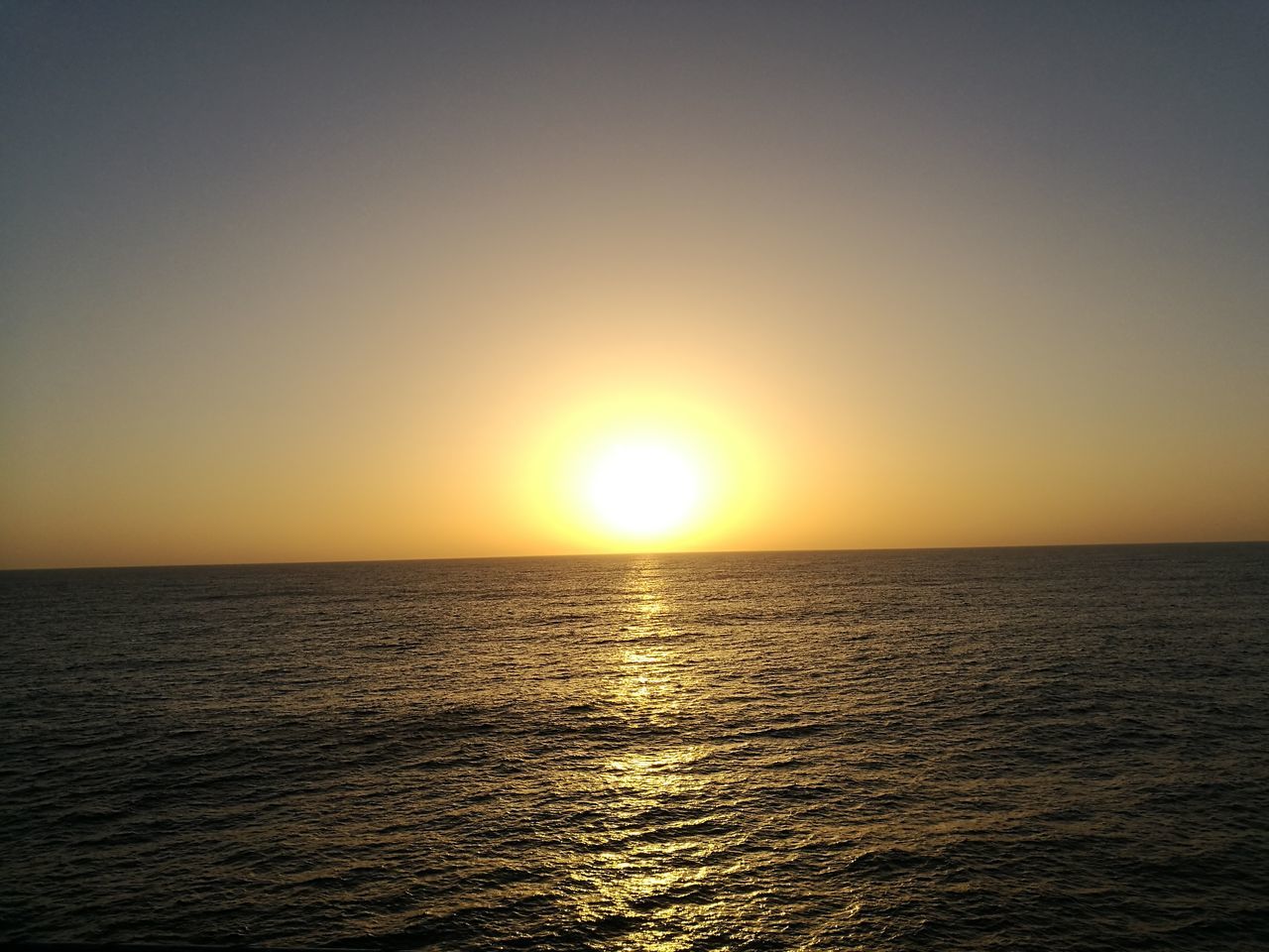 sunset, sun, scenics, tranquility, tranquil scene, sea, nature, beauty in nature, water, idyllic, orange color, sunlight, reflection, horizon over water, no people, shiny, outdoors, sky