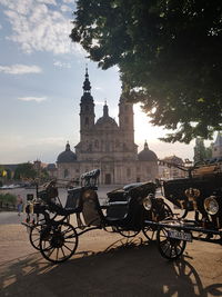 Vehicle parked against fulda cathedral on road in city