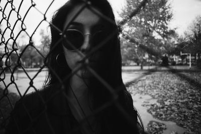 Close-up portrait of woman against trees