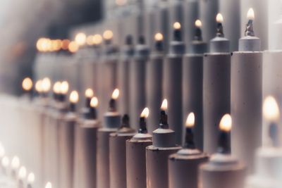 Close-up of burning candles in temple