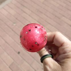 Close-up of hand holding strawberry