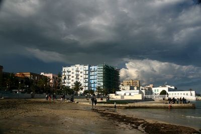 City at beach against sky