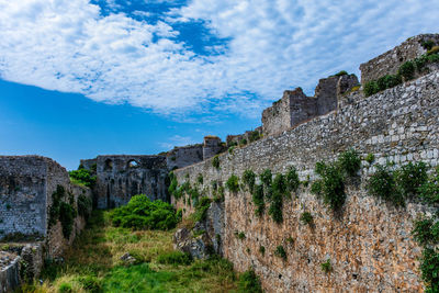 Low angle view of fort against cloudy sky