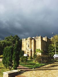 Buildings against cloudy sky