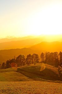 Scenic view of field against cloudy sky