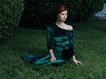 Young woman sitting on field