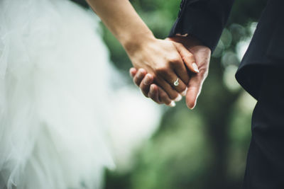 Close-up of couple holding hands