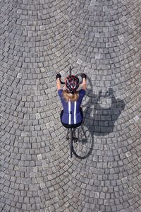 High angle view of people on cobblestone street