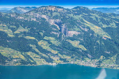Aerial view of sea and mountains against sky