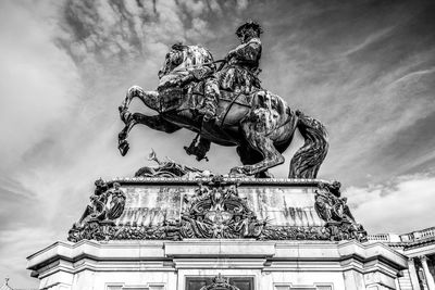 Low angle view of statues against sky