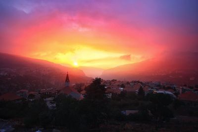 View of town against sky at sunset