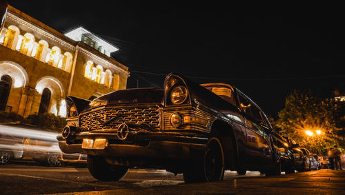 Cars on city street at night