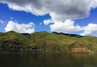 Scenic view of lake and mountains against sky