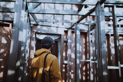 Rear view of man standing in building