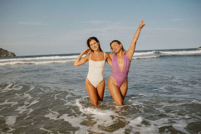 Full length of girl playing at beach