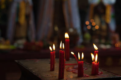 Close-up of burning candles in church