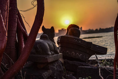 Close-up of sculpture against sky during sunset