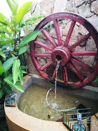 Close-up of water wheel against plants