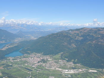 Aerial view of city and mountains against sky