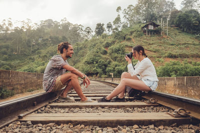 Men sitting on railroad track