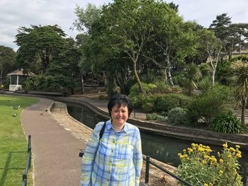 Portrait of smiling woman standing in park