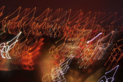 Close-up of illuminated fireworks against sky at night