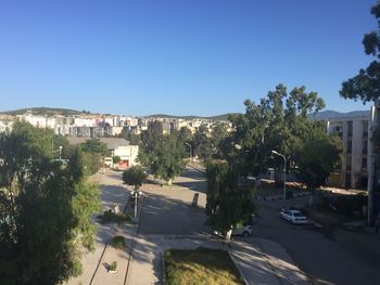 Street in town against clear blue sky