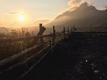 Scenic view of land against sky during sunset