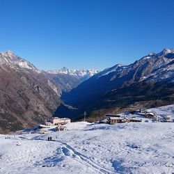 Scenic view of snowcapped mountains against blue sky