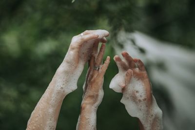 Close-up of hands covered in soap sud