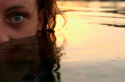 Close-up portrait of young woman in water