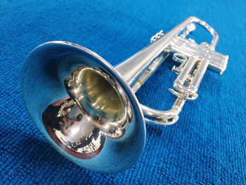 High angle view of trumpet on blue fabric
