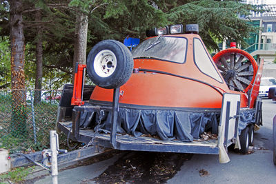 View of abandoned car on road in forest