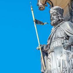 Low angle view of statue against blue sky