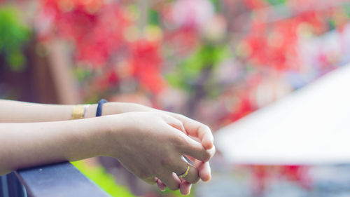 Close-up of woman hand over blurred background